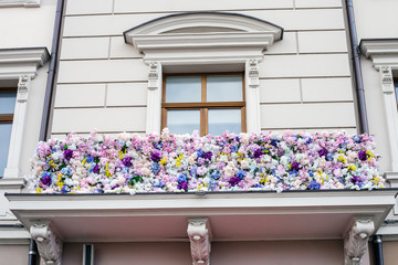 Balcony of house decorated with artificial flowers