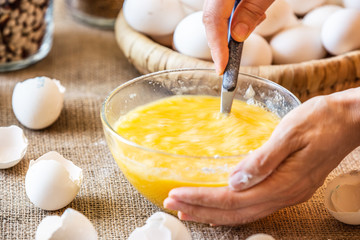 Stir a spoonful of raw eggs in a glass dish.