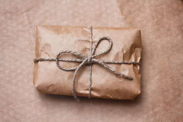 Parcel wrapped by brown craft paper and tie hemp thread. 