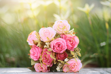Pink Roses bouquet on concrete floor in the garden with sunlight and green natural background. Valentine Day for love and celebration Concept.