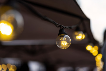 lighting from small light bulbs in a summer cafe