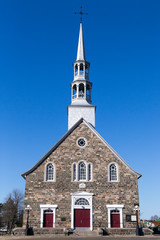 Pretty 1845 patrimonial fieldstone catholic village church, Cacouna, Quebec, Canada