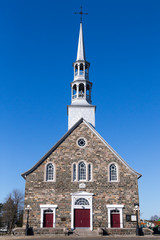 Pretty 1845 patrimonial fieldstone catholic village church, Cacouna, Quebec, Canada
