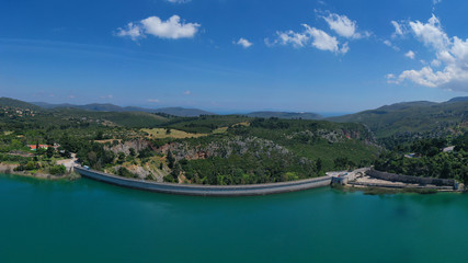 Fototapeta na wymiar Aerial drone photo of famous lake and dam of Marathon or Marathonas with beautiful clouds and blue sky, North Attica, Greece