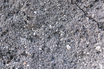 Old asphalt with cracks. The texture of the damaged pavement.