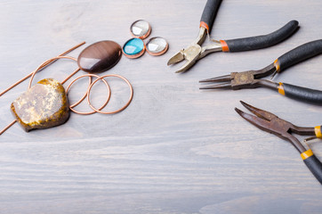 Jewelry tools on wood background