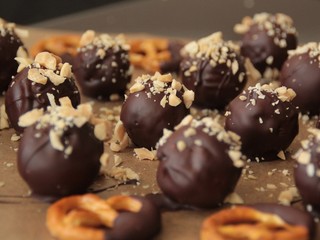 Closeup of vegan chocolates sprinkled with peanuts and pretzels.