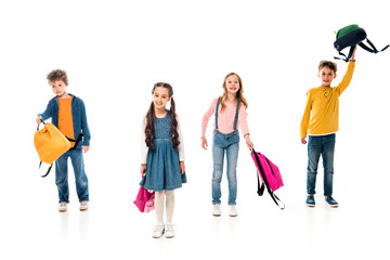 full length view of schoolkids with backpacks on white
