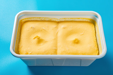 side view box of mango flavor ice cream on blue background