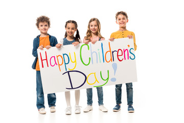 Obraz premium full length view of smiling kids holding placard on white
