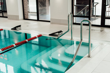 modern swimming pool with lane dividers, pull buoys and swimming kickboards