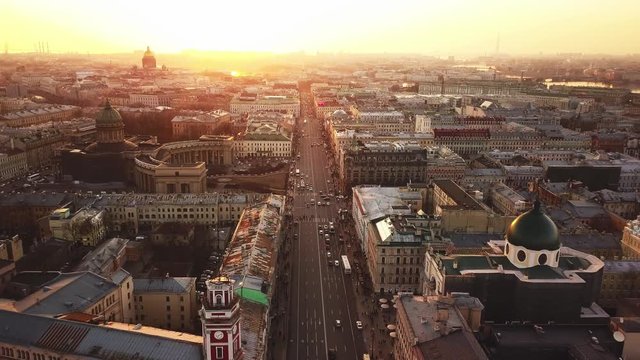 Aerial spring sunset view of Saint Petersburg Nevsky prospect Kazan cathedral Kazanskiy Kafedralniy Sobor Singer House of the Book church roofs road cars rooftops famous place of Russia religion