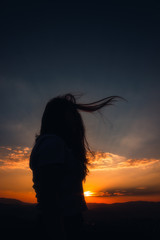 silhouette of woman at sunset