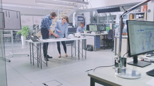 In the Busy Engineering Facility: Diverse Group of Engineers, Technicians, Working on Design for Industrial Engine Prototype