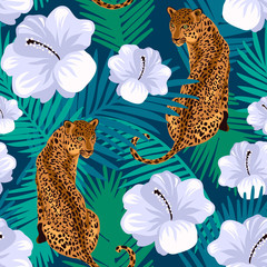 Floral jungle leopard seamless pattern.  Animal print pattern with tropical leaves and flowers in deep blue background. © LilaloveDesign
