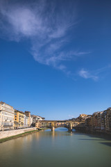 Obraz premium Sunny view on the Arno River and Ponte Vecchio in Florence, Italy
