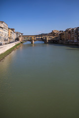 Obraz premium Sunny view on the Arno River and Ponte Vecchio in Florence, Italy