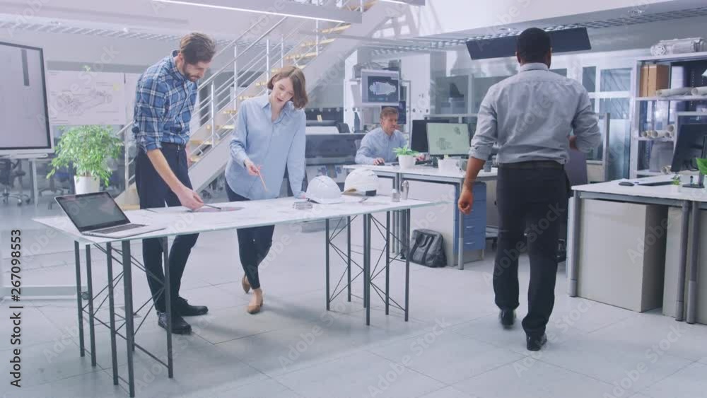 Aufkleber in the busy engineering facility: diverse group of engineers, technicians, working on design for ind