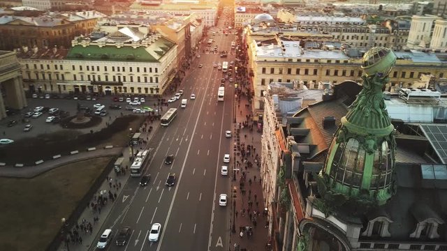 Aerial spring sunset view of Saint Petersburg Nevsky prospect Kazan cathedral Kazanskiy Kafedralniy Sobor Singer House of the Book tower church roofs road cars rooftops famous place of Russia religion