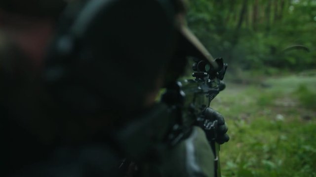 The soldier shoots at the target. Military mission.