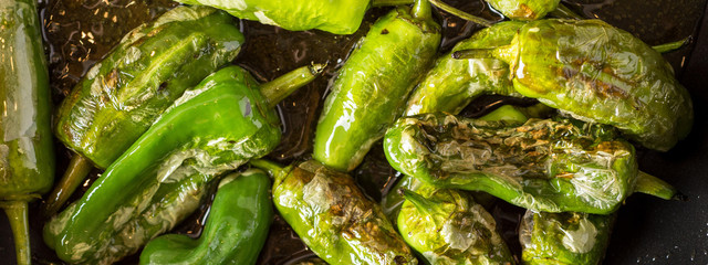 Pimientos de Padrón. Preparing Green Padron Peppers in the Frying Pan.