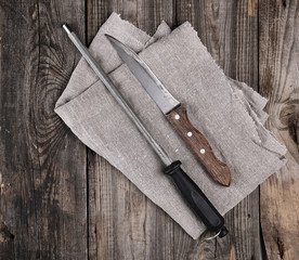 knife with sharpening on the wooden table