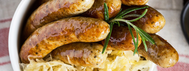 Traditional German Sausages with Cabbage Salad, Mustard and Beer. Bratwurst and Sauerkraut.