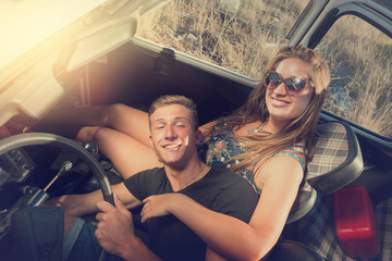 Fototapeta na wymiar Couple in a car at sunset
