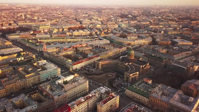 Aerial spring sunset view of Saint Petersburg Nevsky prospect Kazan cathedral Kazanskiy Kafedralniy Sobor Singer House of the Book tower Griboyedov Canal church roofs road cars rooftops famous place