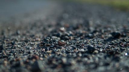 Close up on gravel on a gravel road in the summertime
