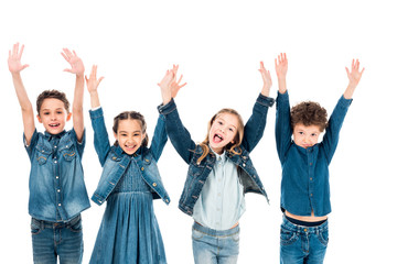 front view of four kids in denim clothes smiling with hands up isolated on white