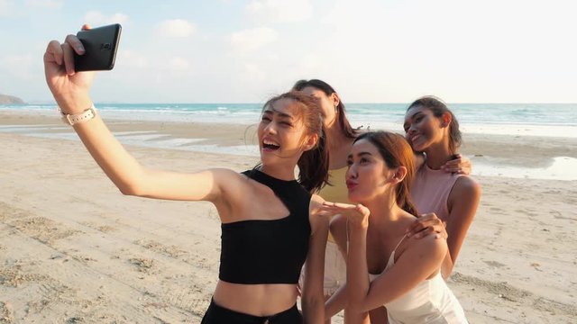 Asian girl group photography selfie with smartphone together at seaside beach summer. Young asia happy emotion and anniversary celebration. 4K resolution and slow motion.