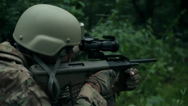 Shot at the target. Portrait. Fire ball. Shooting with an automatic rifle.