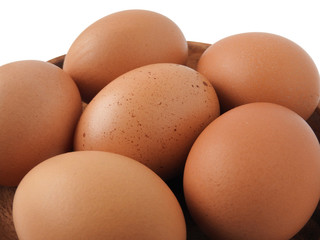 High angle view of raw brown eggs on wooden plate isolated on white background. Eggs are a common ingredient in cooking.  Egg protein is a protein that can be absorbed efficiently. Food concept.