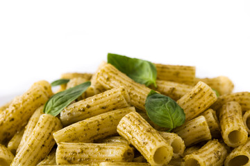 Penne pasta with pesto sauce and basil on a plate isolated on white background