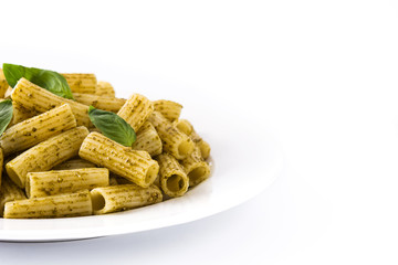 Penne pasta with pesto sauce and basil on a plate isolated on white background