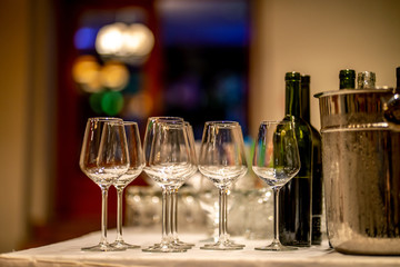 Wine glasses, bottles and ice bucket on table