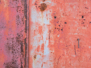 Old paint on metal surface, rust stains.