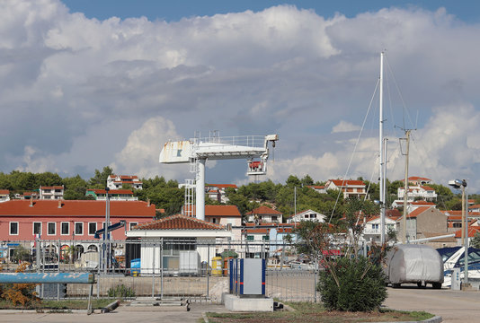 Crane lift for raising boats in the marina ACI Jazera in Croatia. Dalmatian ragion of Adriatic sea at Mediterranean area. The ships moored in the port of a quiet fishing town in a sunny,clear day