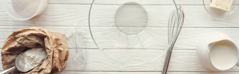 top view of bowl, flour and kitchen utensils on table