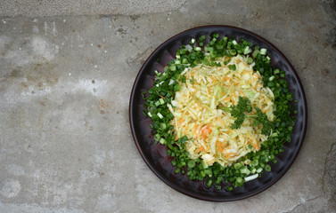 Salad on a plate on a stone background.