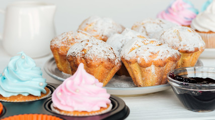 selective focus of muffins decorated with powdered sugar on plate