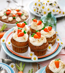 Carrot cake muffins with mascarpone cream,  topped with marzipan carrots. Delicious homemade dessert.