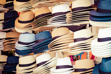 several straw hats in a flea market