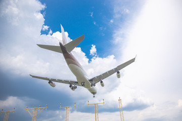 Close-up of a passenger plane landing at the airport against a blue sky