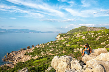 Young beautiful girl traveling along the coast of the Mediterranean Sea.