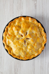 Homemade american apple pie dessert on a white wooden background, top view. Flat lay, overhead, from above.