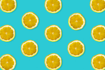 Creative pattern made of lemon. top view of fruit fresh limes slices on blue colorful background. 
