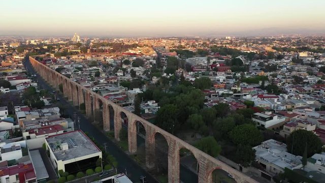 Cinematic Drone Aerial Of Historic Aqueduct in Queretaro City in Central Mexico With Car Traffic on Sunny Morning 4k