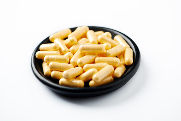 Coenzyme Q10 capsules. Concept for a healthy dietary supplementation. White background. Close up. 